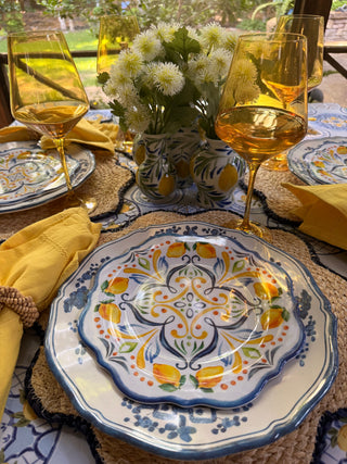 Colorful table set for an afternoon gathering with flowers and entertaining accessories.