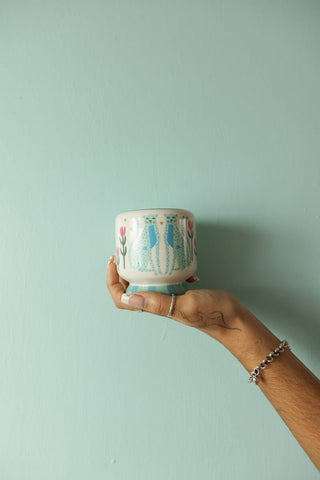 A Dopo Blue Cheetahs candle held in hand