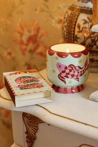 A Dopo Koi candle lit beside matches