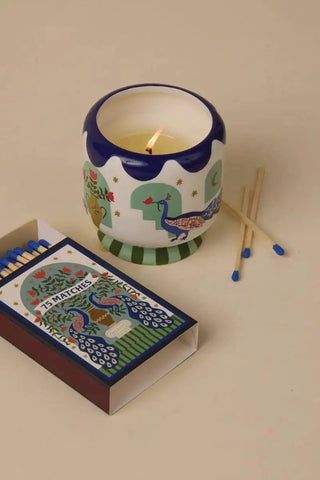 A Dopo Peacock candle with matching boxed matches