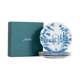 A set of four blue and white porcelain plates with a scenic landscape illustration, displayed next to a teal gift box with the brand name 'Sielker' on a white background.