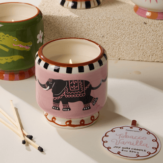 A Dopo Elephant candle with tag and matches
